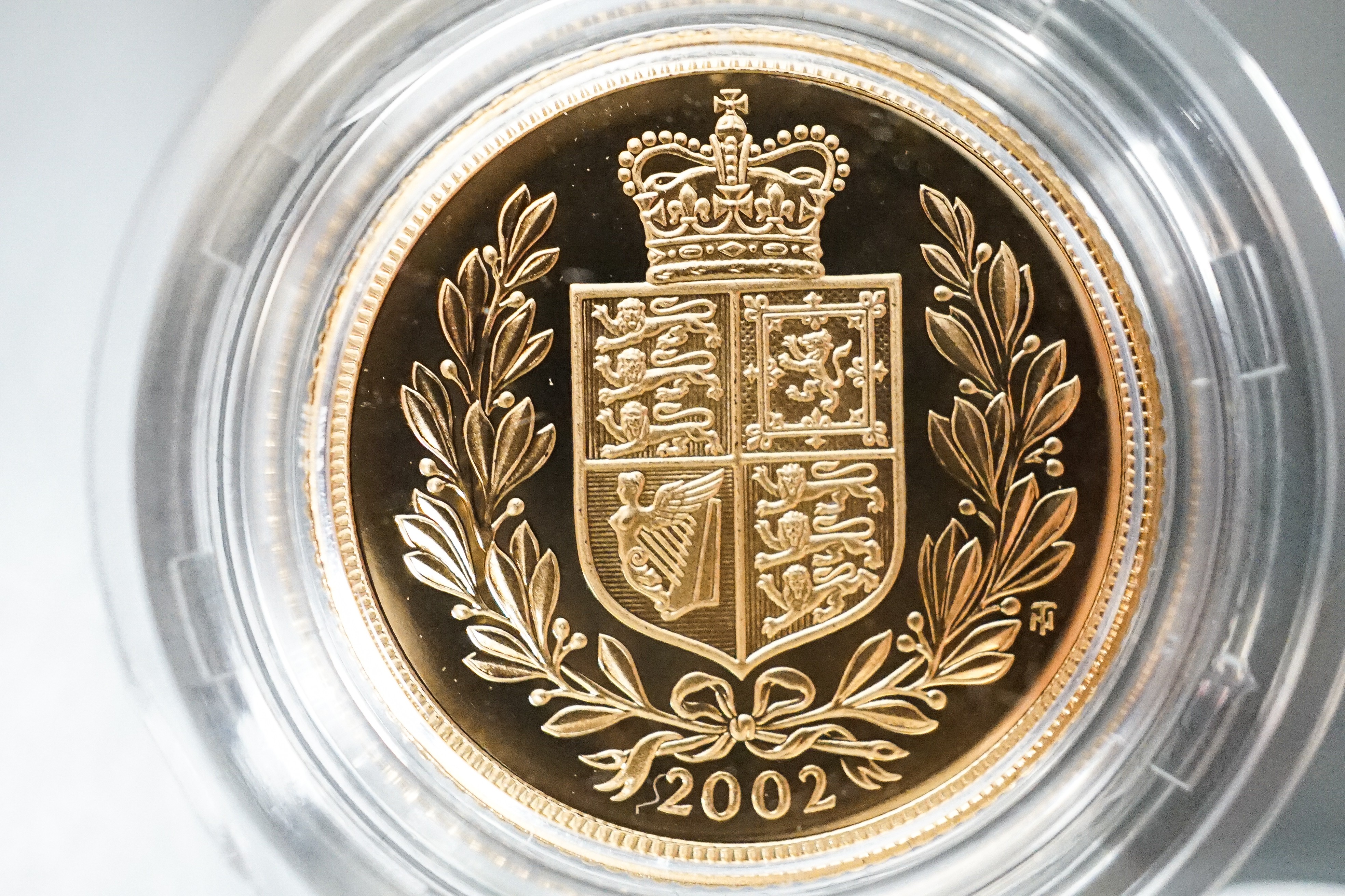 A Royal Mint gold proof sovereign, 2002, cased with certificate and a similar half sovereign (2)